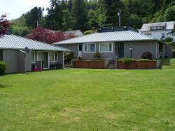 Fourplex public housing buildings in the background and manicured grass in front.